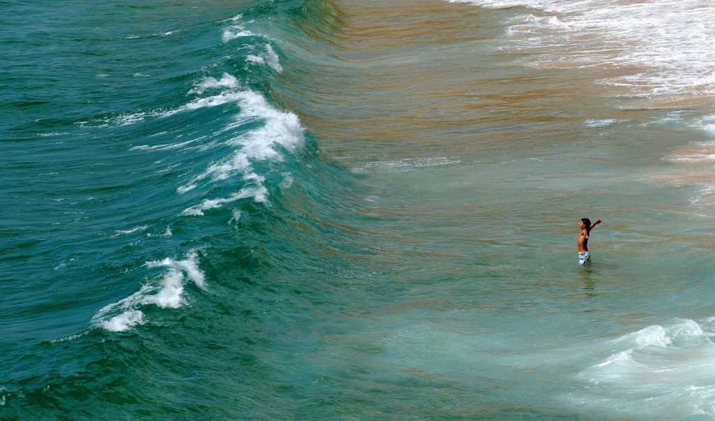 Aerial view of ocean waves and deep blue water